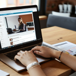 **

"A freelancer working on a laptop in a modern co-working space, with a LinkedIn profile displayed on a second screen. Coffee cup and marketing certification visible on the desk. The overall mood is productive and independent, bathed in natural light. Soft focus, shallow depth of field."

**